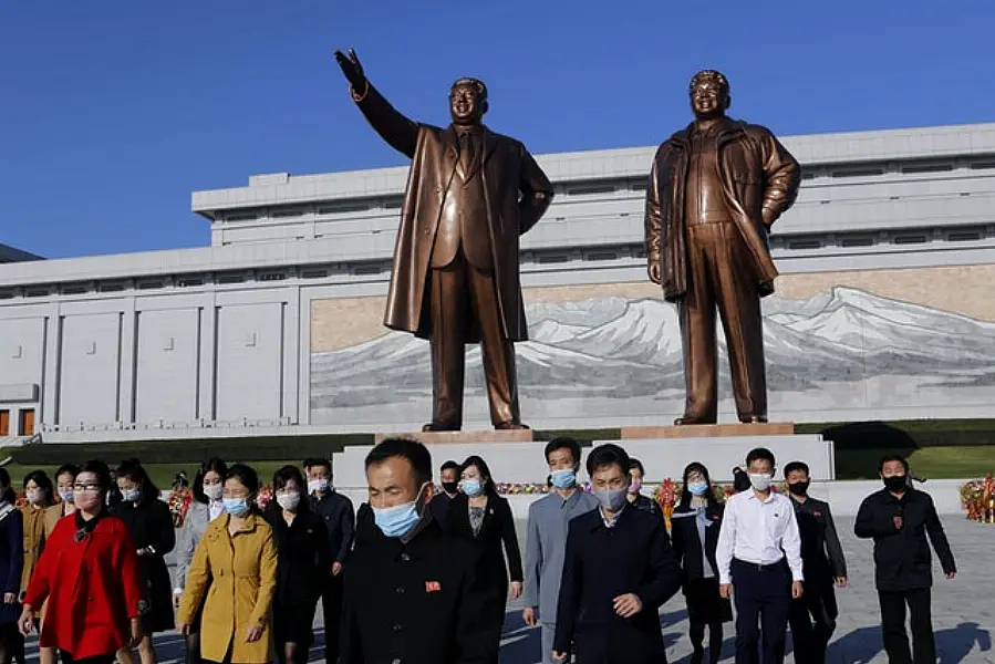 People visit the Mansu Hill to lay flowers to the bronze statues of former North Korean leaders Kim Il Sung and Kim Jong Il (Cha Song Ho/AP)