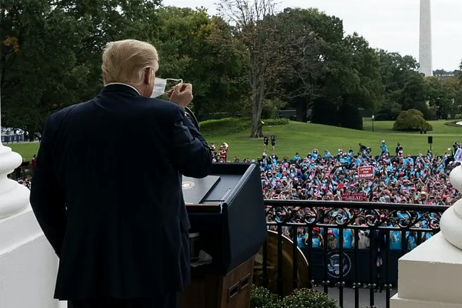 President Donald Trump removes his mask before speaking (Alex Brandon/AP)