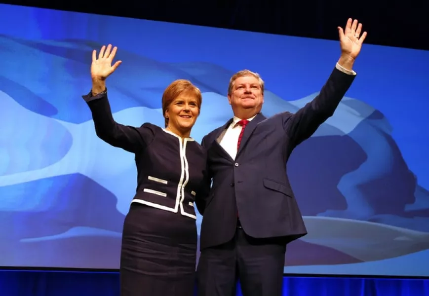 First Minister and SNP leader Nicola Sturgeon with former deputy party leader Angus Robertson (Andrew Milligan/PA)