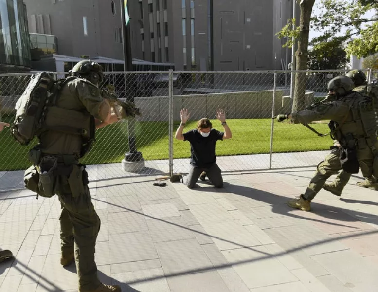 A man is taken into custody after the fatal shooting (Helen H. Richardson/The Denver Post/AP)