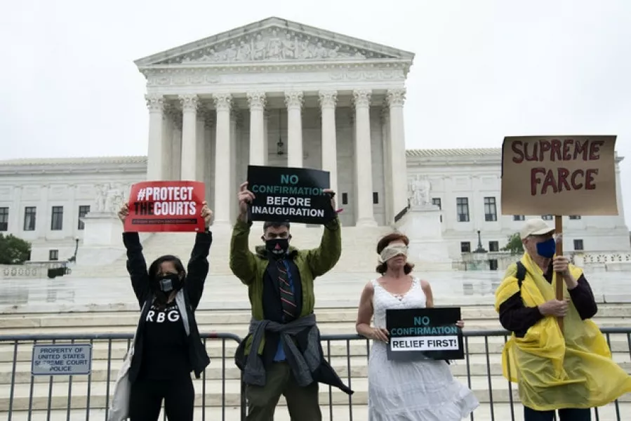 Protesters opposed to the confirmation of President Donald Trump’s Supreme Court nominee Amy Coney Barrett, rally at the Supreme Court (Jose Luis Magana/AP)