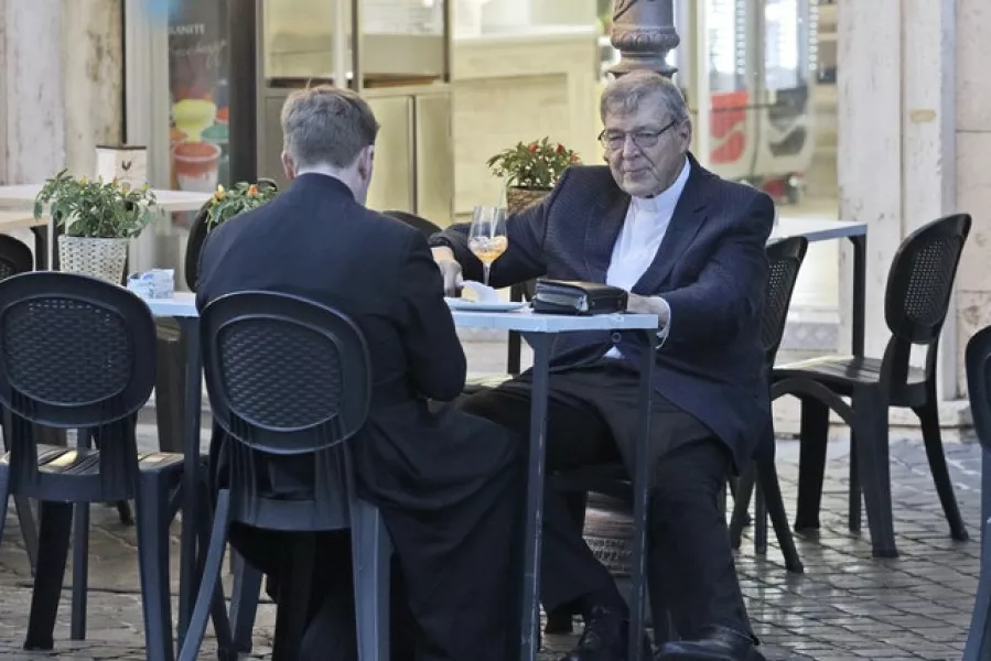 Cardinal George Pell, right, has a drink in a cafe at the Vatican (AP/Gregorio Borgia)
