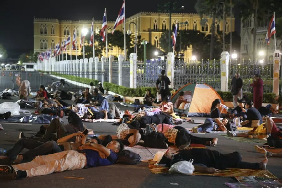 Protesters sleep in front of Government House (Rapeephat Sitichailapa/AP)