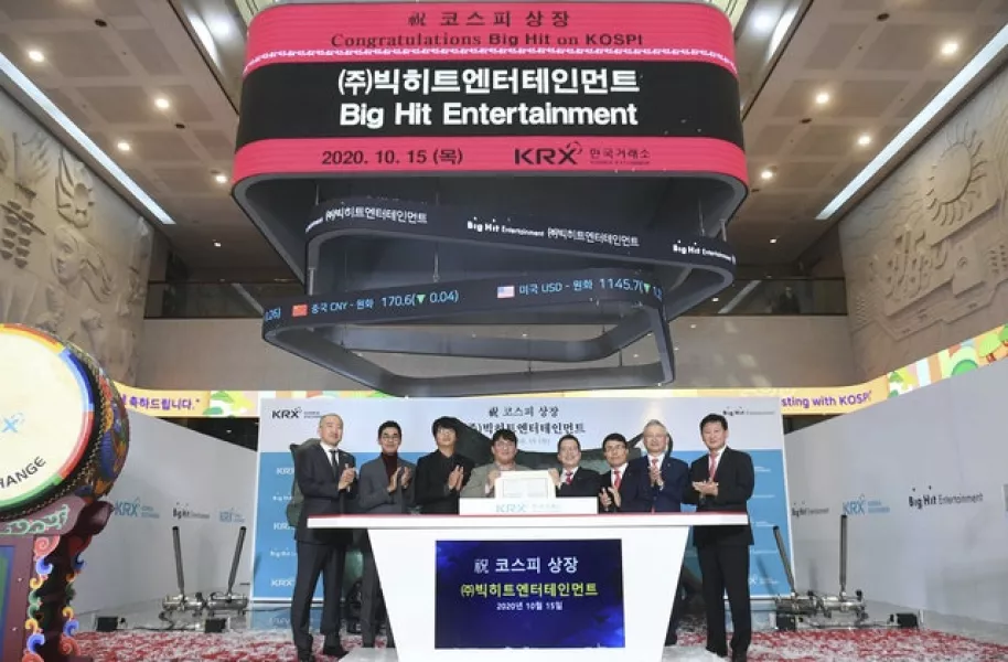 Big Hit Entertainment Ltd’s chairman and CEO Bang Si-Hyuk, fourth from left, during the listing ceremony of the compnay at the Korea Exchange in Seoul (Korea Pool/Yonhap via AP)