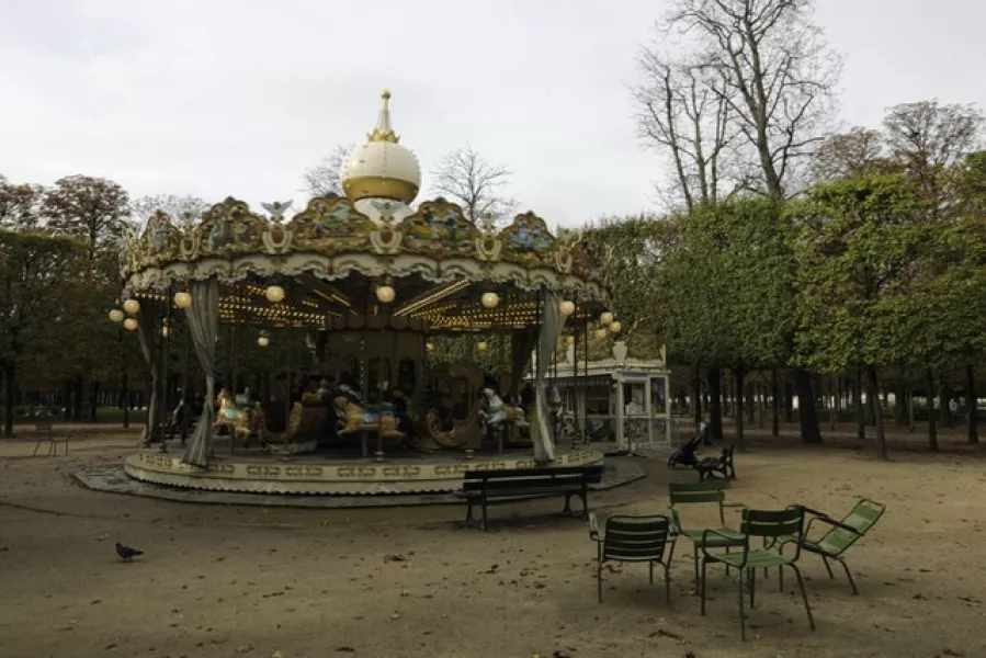 An empty carousel is pictured in the Tuileries gardens in Paris (Lewis Joly/AP)