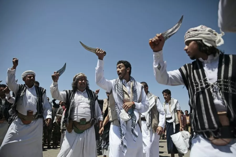 A Yemeni prisoner, centre, performs a traditional dance (Hani Mohammed/AP)
