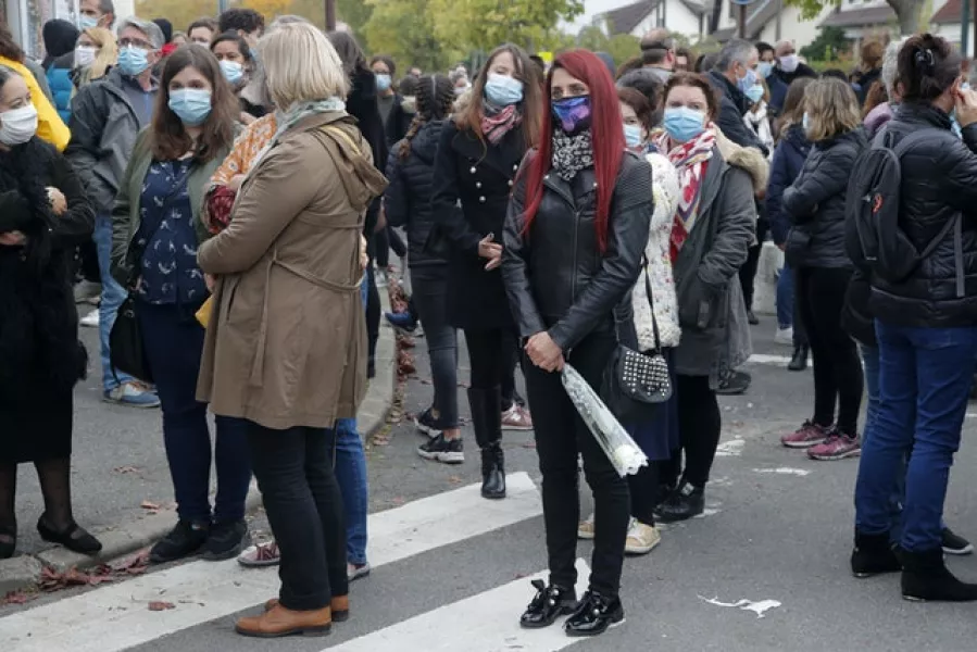 Residents gather outside the school (Michel Euler/AP)