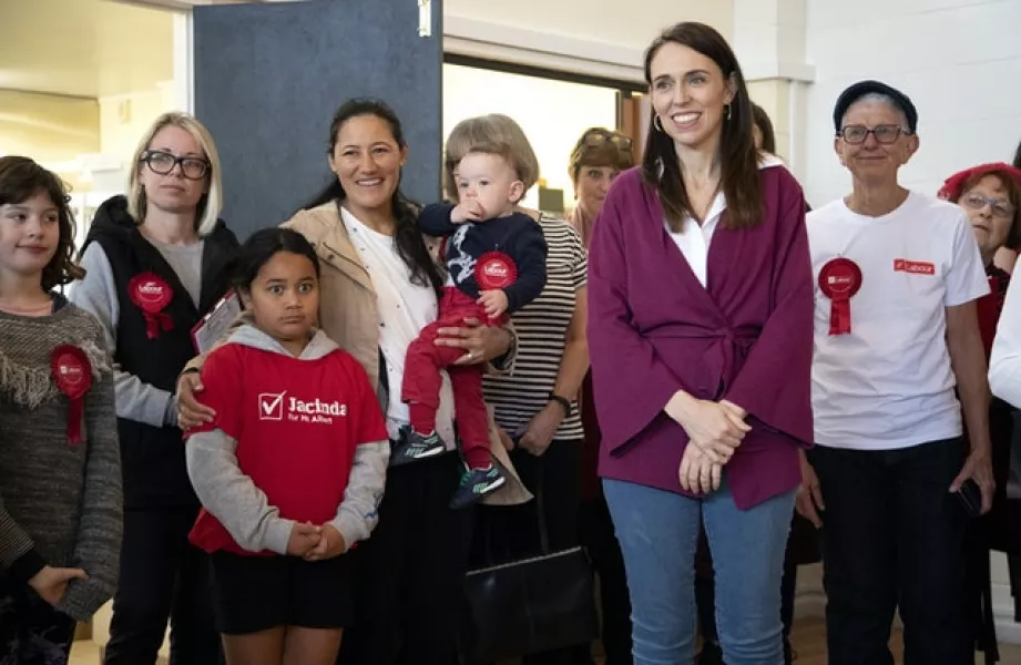 Ms Ardern stands with her electorate workers at an event in Auckland (AP)