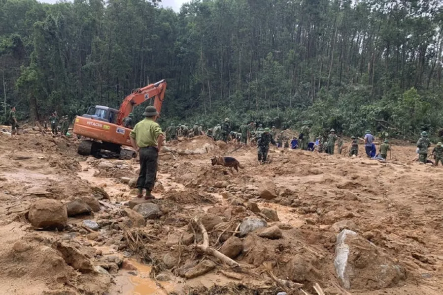 Rescue workers recover bodies of army officers buried in a landslide in Thua Thien-Hue province, Vietnam on Thursday (Tran Le Lam/VNA/AP)