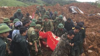 Rescuers Search For 22 Buried As Vietnam Landslide Hits Army Camp