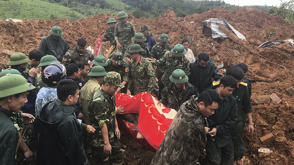 Rescuers Search For 22 Buried As Vietnam Landslide Hits Army Camp