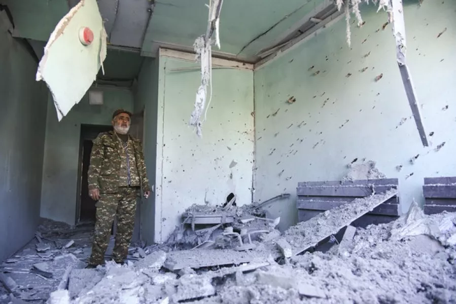 A man stands inside a house destroyed by shelling in Stepanakert, in the separatist region of Nagorno-Karabakh (David Ghahramanyan, NKR InfoCenter/PAN Photo/AP)