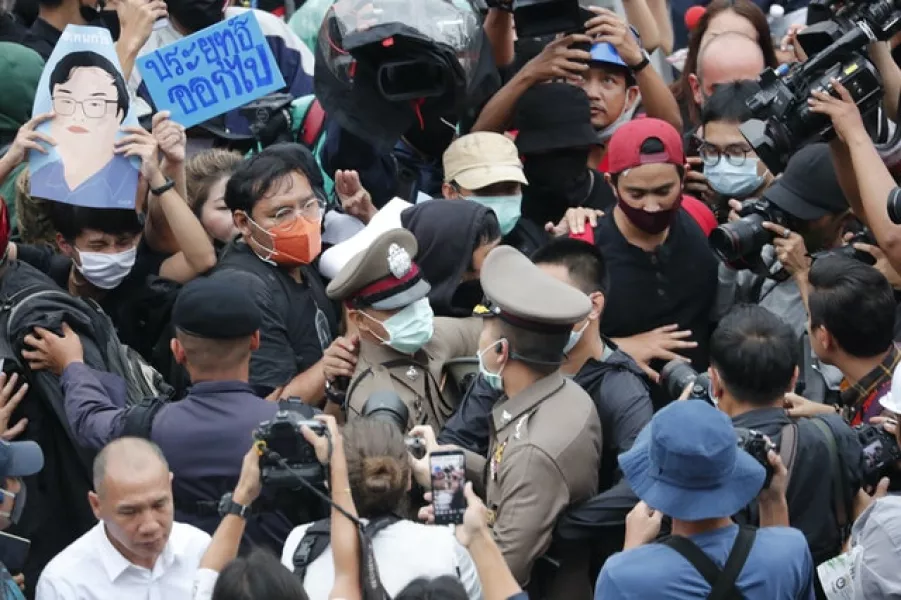 Police officials scuffle with pro-democracy demonstrators in Bangkok (AP)