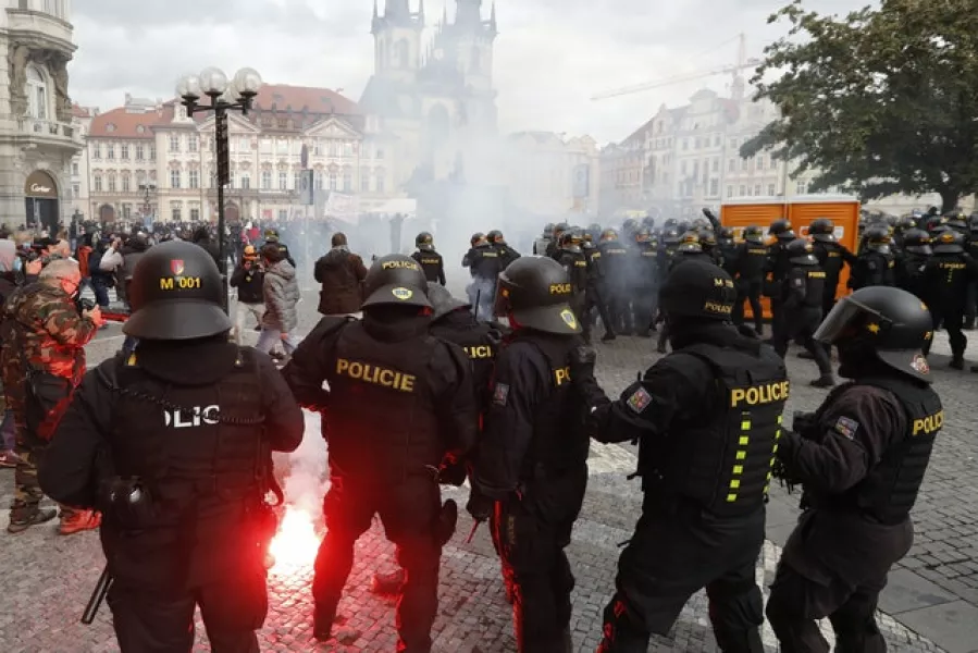 Police confront demonstrators in Prague as they protest against Covid-19 restrictions (Petr David Josek/AP)