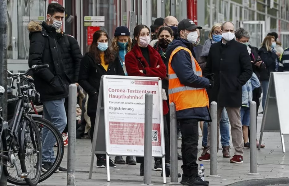 People queue for a coronavirus test in Cologne, Germany (Martin Meissner/AP)