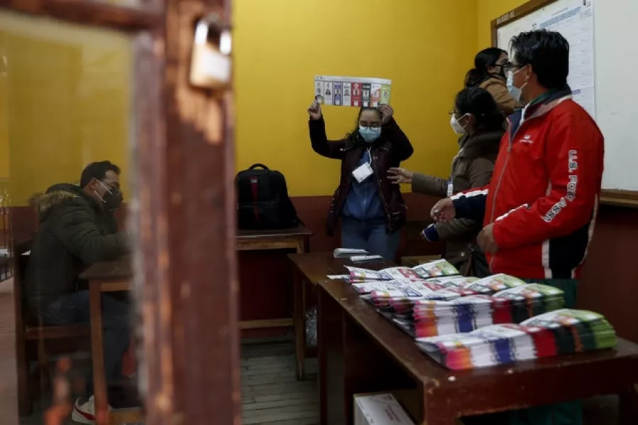 Electoral officials count ballots after polls closed for presidential elections in La Paz, Bolivia (Juan Karita/AP)