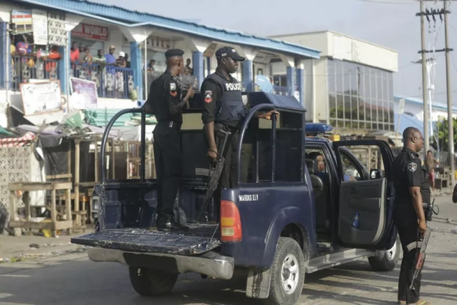 Police officers patrol near the Lekki toll gate in Lagos (Sunday Alamba/AP)