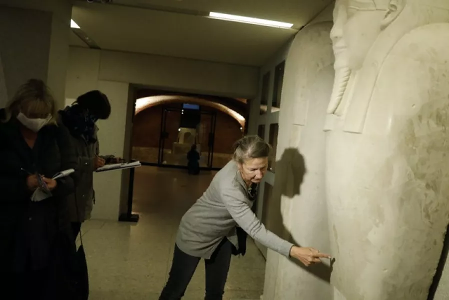 Friederike Seyfried points to a stain on the sarcophagus of the prophet Ahmose at the Egyptian Court of the Neues Museum (Markus Schreiber/AP)