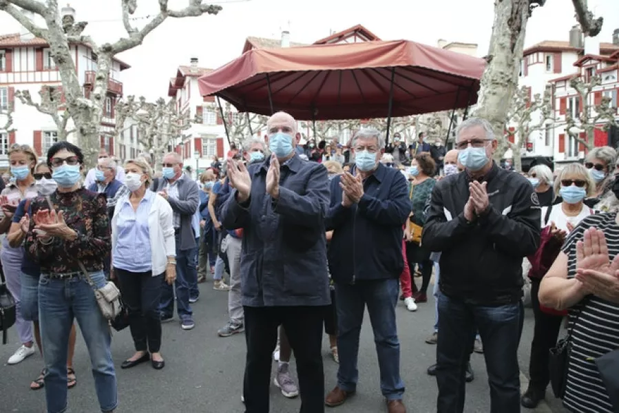 Residents applaud after observing a minute of silence for Samuel Paty in Saint-Jean-de-Luz (Bob Edme/AP)