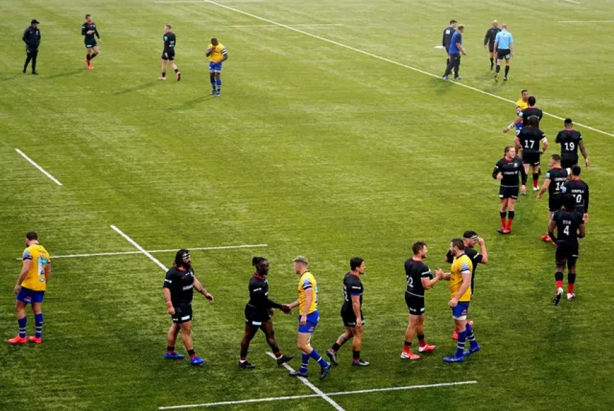 Saracens and Bath players shake hands at the end of the match (John Walton/PA).