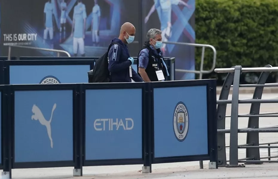 Pep Guardiola arrives at the Etihad Stadium in a mask as football resumed after the coronavirus pandemic (Martin Rickett/PA)
