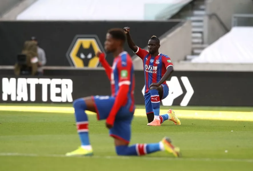 Wilfried Zaha takes a knee for Black Lives Matter prior to a Premier League game (Martin Rickett/NMC Pool/PA)