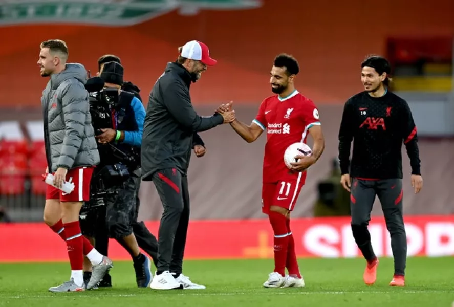Liverpool manager Jurgen Klopp, centre left, congratulates Mohamed Salah on his hat-trick against Leeds (Shaun Botterill/PA)