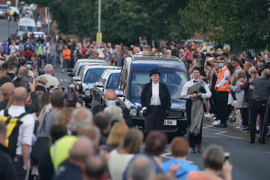 People line the streets as the funeral cortege of Jack Charlton passes through his home town of Ashington (Owen Humphreys/PA)