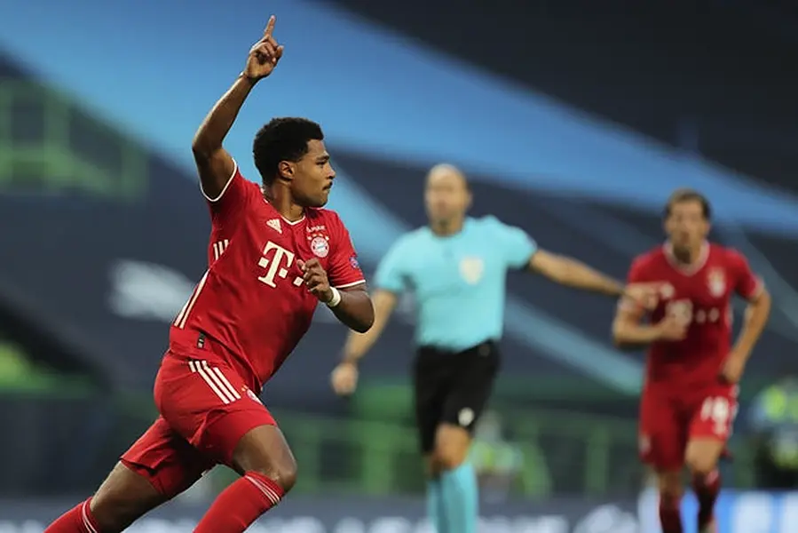 Serge Gnabry celebrates after scoring against Lyon (Miguel A Lopes/AP)