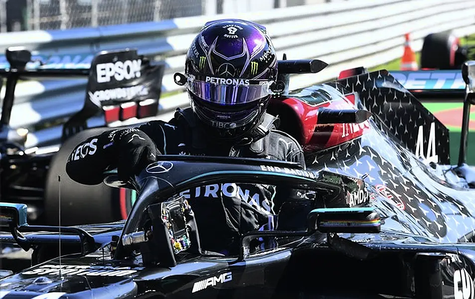 Hamilton leaves his car after making history at Monza (Jennifer Lorenzini/AP)