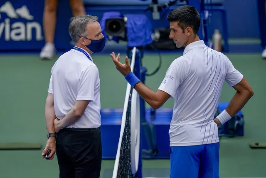 Novak Djokovic speaks with the umpire after hitting a line judge (Seth Wenig/AP)