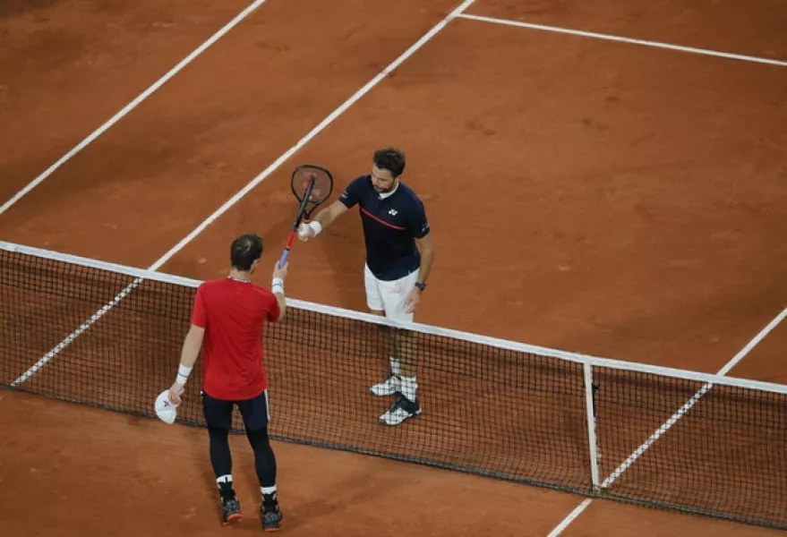 Andy Murray and Stan Wawrinka touch rackets at the end of the match (Christophe Ena/AP)