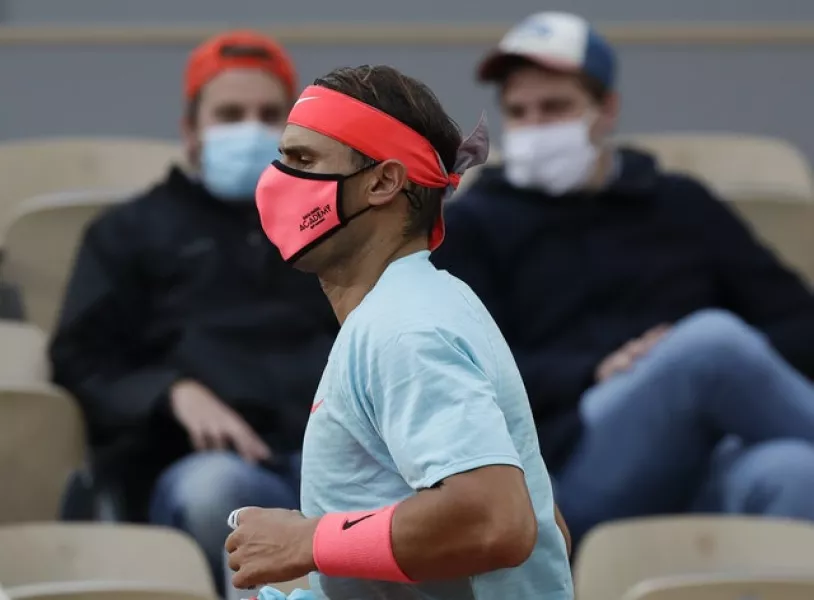 A sign of the times. Rafael Nadal, a mask, and a smattering of spectators (Alessandra Tarantino/AP)