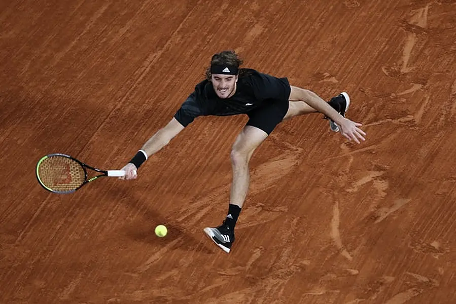 Stefanos Tsitsipas stretches for a forehand against Novak Djokovic (Alessandra Tarantino/AP)