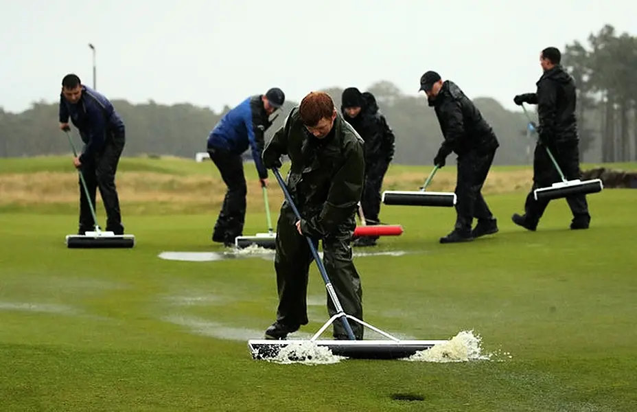 Ground staff clear the waterlogged green on the 18th during the third round of the ASI Scottish Open at The Renaissance Club (Jane Barlow/PA)