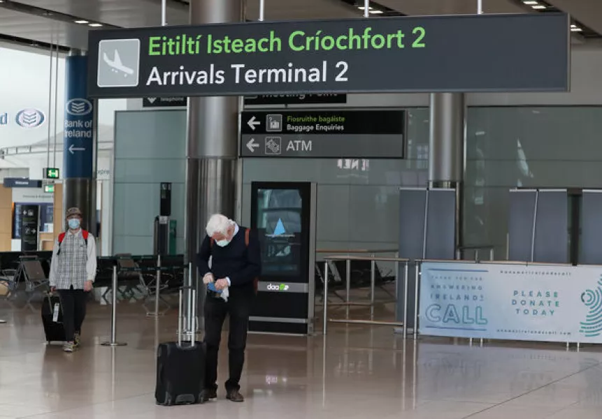 People wearing protective face masks in Terminal 2 in Dublin Airport as a requirement for people arriving in Ireland from overseas to alert the authorities where they will be self isolating has come into effect.