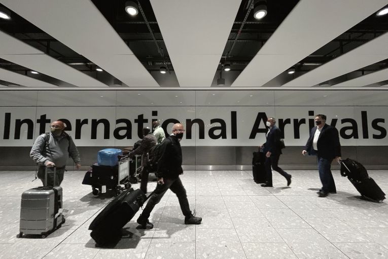 Passengers in the arrivals area at Heathrow Airport earlier this week: all flights from seven southern African countries into Britain have been suspendedGetty