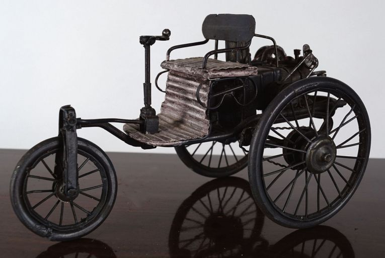 Vintage wheeled oddities are a decanter carriage and a model of a three-wheeled motorcycle, each with an estimate of €200-€300.