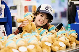 Oisín in Tesco with a collection of Simon the Sloth teddies