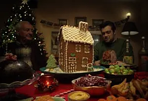 Conor and his granddad with a gingerbread house in Tesco Ireland's 2024 christmas ad