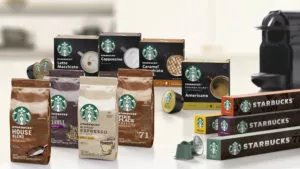 A collection of Starbucks at-home products on a table, including ground coffee and coffee pods