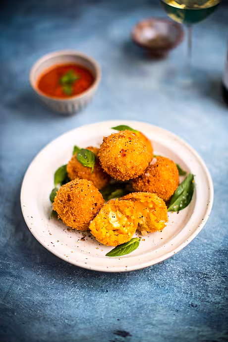 Mozzarella Arancini with Sweet & Spicy Marinara | DonalSkehan.com, Cheese stuffed rice balls, deep-fried until golden brown.