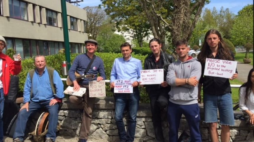 Protestors gather at City Hall over proposed busking regulations