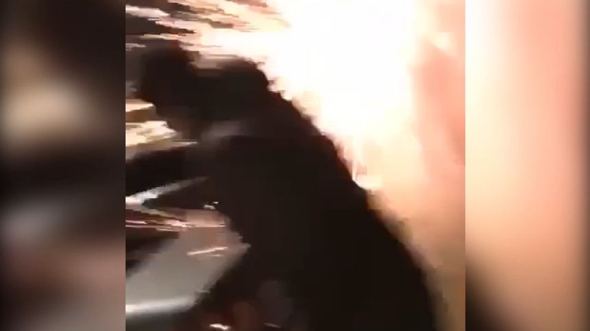 Fireworks exploding in young mans hands