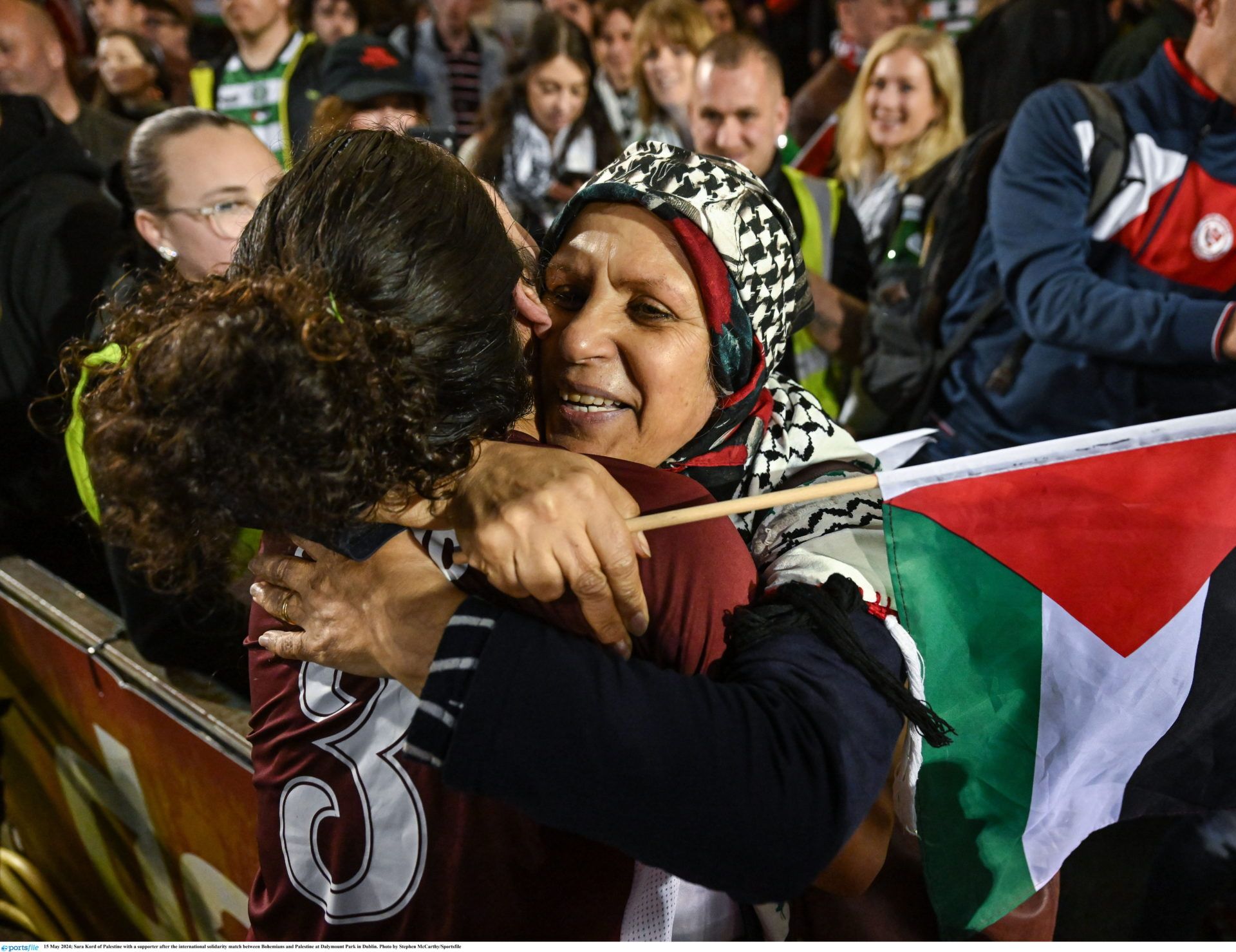 15 May 2024; Sara Kord of Palestine with a supporter after the international solidarity match between Bohemians and Palestine at Dalymount Park in Dublin. Photo by Stephen McCarthy/Sportsfile
