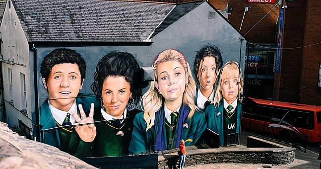 Iconic Derry Girls mural partially obscured by bar awning | Hotpress