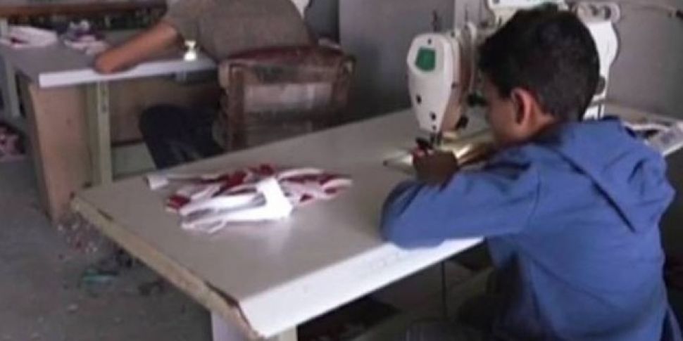 Syrian children making clothes...