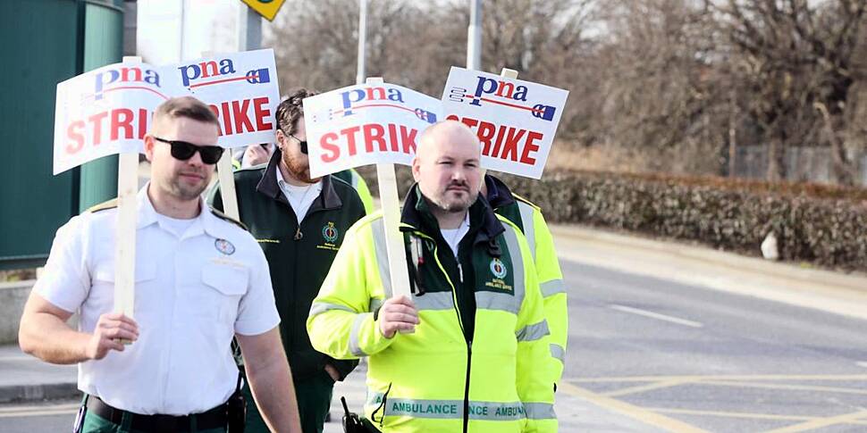 Ambulance workers holding fift...