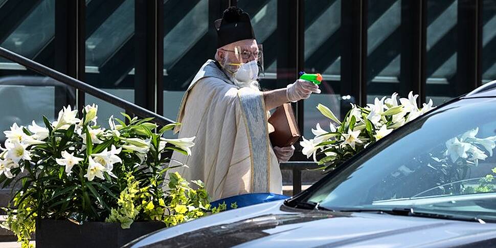 A Detroit priest doing blessin...