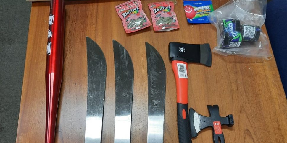 Two men charged after machetes...